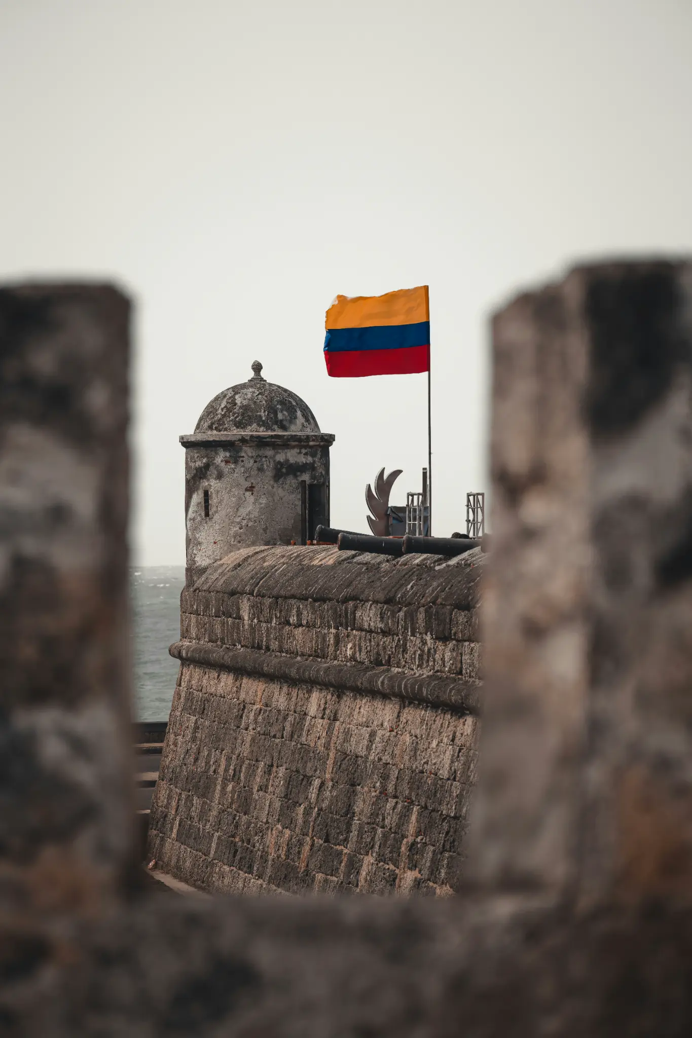 Colombian flag flying over the stone battlements of Castillo San Felipe de Barajas in Cartagena