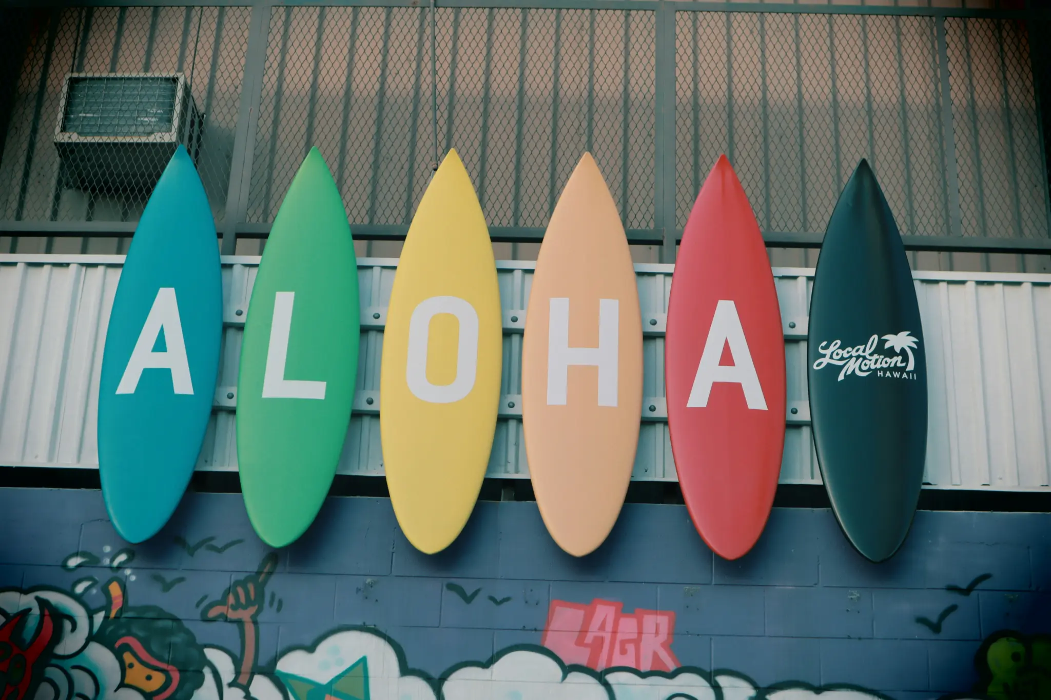 Colourful surfboard ALOHA sign at Local Motion Hawaii