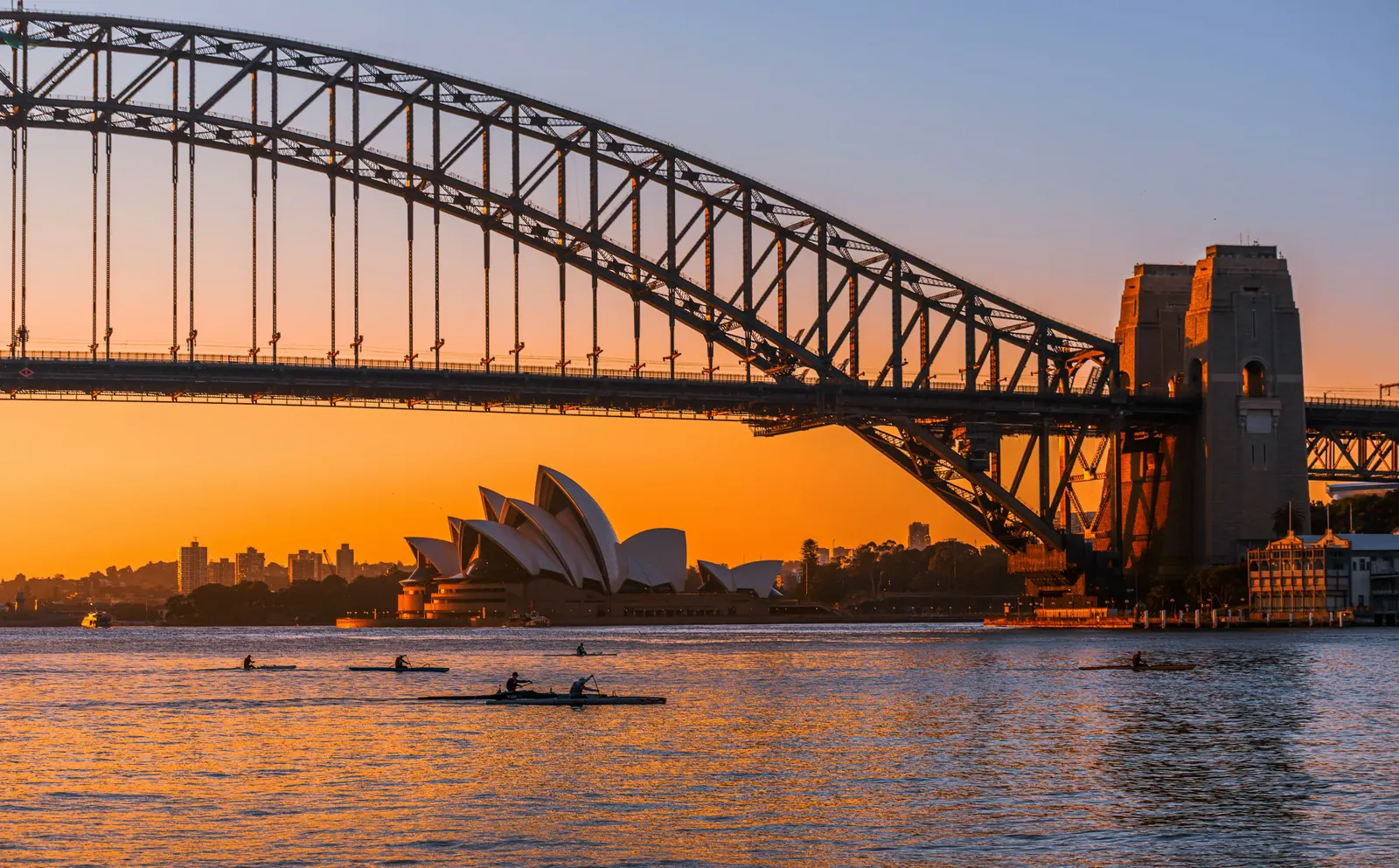 Sydney Harbour at sunrise with the Opera House and Harbour Bridge